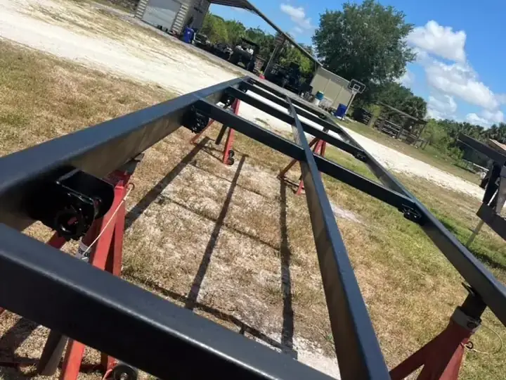 The same trailer frame after blasting and a fresh coat of black paint