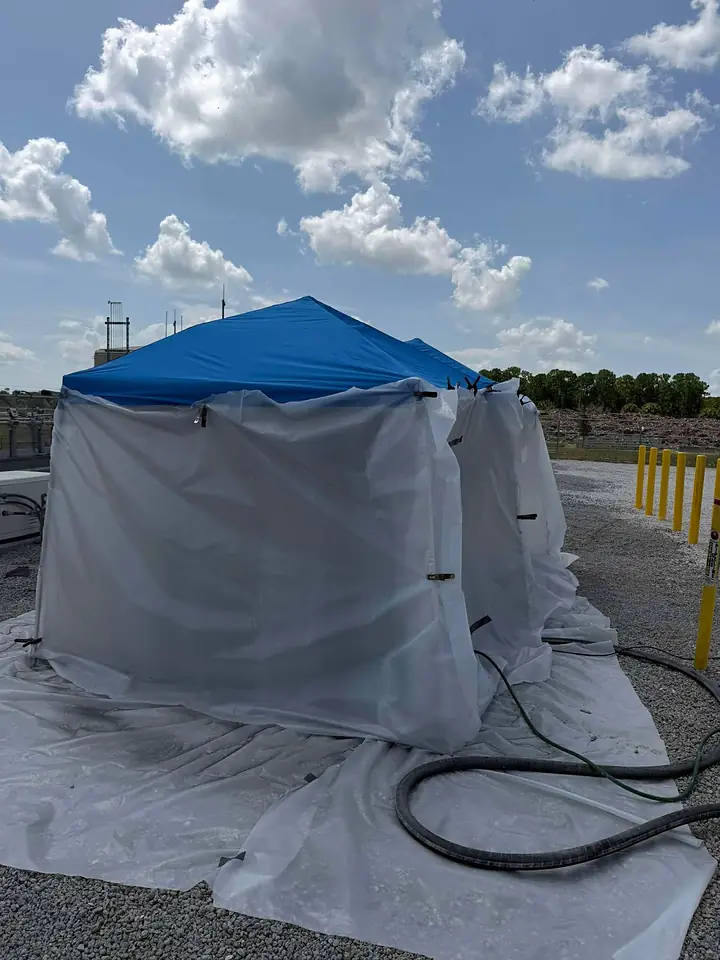 Containment tent set up over gas line piping before blasting