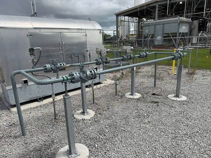 Gas station piping and supports blasted and coated gray