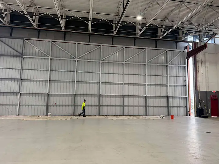 Tall hangar wall painted by our crew in a commercial building