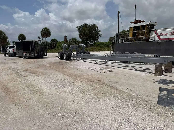 Our blast rig and truck next to a sand mine dredge and freshly coated steel